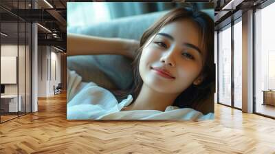 Relaxing home lifestyle happy woman in relax luxury hotel room sofa lying back with arms behind head smiling. Asian girl in comfortable lounging chair, Generative AI Wall mural