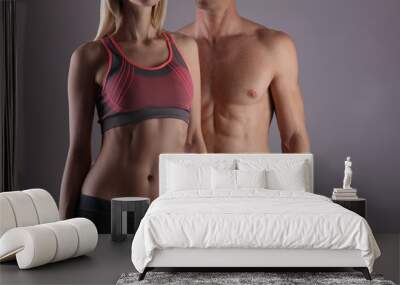 Fit couple, strong muscular man and slim woman . Sport, fitness ,workout concept. Copy space Wall mural