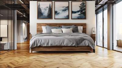 A cozy bedroom interior, wooden bed frame with gray bedding, two nightstands with table lamps, three framed landscape photos on the wall depicting trees and misty scenery, minimalist decor with a pott Wall mural