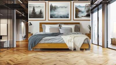 A cozy bedroom interior, wooden bed frame with gray bedding, two nightstands with table lamps, three framed landscape photos on the wall depicting trees and misty scenery, minimalist decor with a pott Wall mural