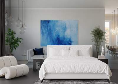 A modern and airy living room with minimalist furnishings, featuring a tufted white sofa with navy blue throw pillows, hanging pendant lights, a large abstract blue artwork on the wall, tall potted pl Wall mural