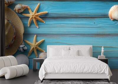 Rustic blue wooden background with a wide variety of seashells scattered around, including scallops, starfish, conch shells, clam shells, seaside travel hat, summer beach vacation concept, vivid color Wall mural