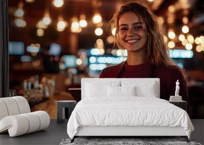 young woman bartender, holding a tablet, casual attire, pub interior, warm lighting, cozy atmosphere, smiling bartender, modern bar, industrial decor, wooden bar counter, hanging lights Wall mural