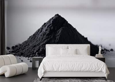 A close-up of charcoal powder in a small pile on a white surface, highlighting its smooth texture and rich black hue Wall mural