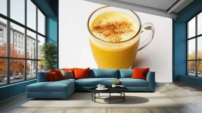 A glass of golden turmeric latte with a sprinkle of cinnamon on top, isolated on a white background Wall mural