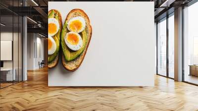 A minimalist breakfast featuring avocado toast with a soft-boiled egg, placed on a white background for a clean, fresh morning meal presentation. Wall mural