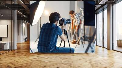 A photographer capturing product images for an advertising shoot, with professional lighting, a camera, and styled props set up in a studio Wall mural