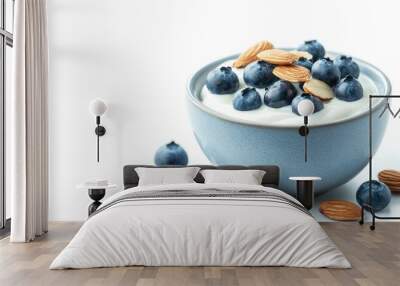 A bowl of Greek yogurt topped with fresh blueberries and almonds, isolated on a clean white background Wall mural