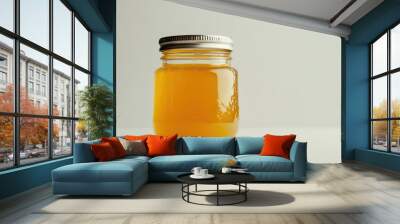 A compact glass jar of orange marmalade, with a glossy metal lid, placed on a white background, showcasing high-end food packaging for gourmet spreads. Wall mural