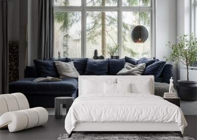 Cozy Scandinavian living room design, with a dark blue corner sofa and two knitted poufs, surrounded by natural light and a calm, modern decor scheme. Wall mural