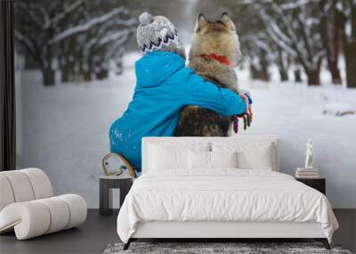 happy boy hugging dog or husky outdoors in winter day Wall mural