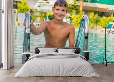 Young boy summer happy and contented in the pool in the summer Wall mural