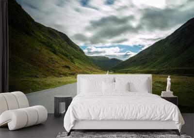 Straight mountain road leading through dramatic valley, Norway. Wall mural