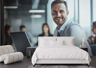 Professional Smiling Man at Laptop in Office Wall mural