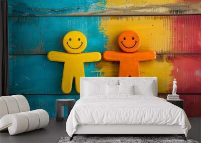 Two wooden figures with smiley faces on colorful background. Wall mural