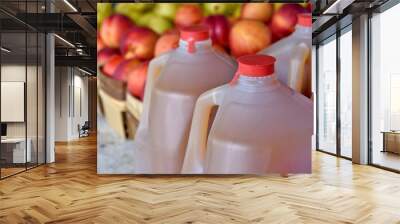 apple cider in jugs with apples at the farmers market Wall mural