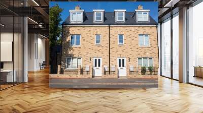 Newly built three floors semi detached houses on an empty street in England, UK Wall mural