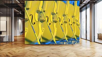 Ten classic yellow violins standing in line under blue background. 3D sketch design and illustration. 3D high quality rendering. Wall mural