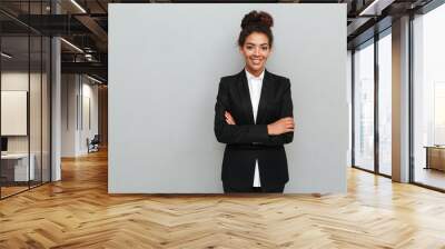 Amazing young african business woman standing over grey wall Wall mural