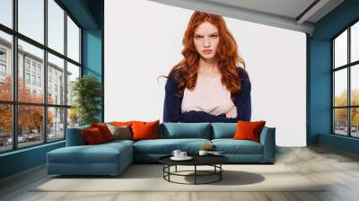 Angry pretty young redhead lady with arms crossed. Wall mural