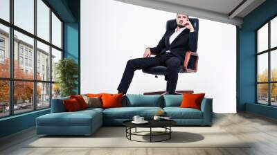 Assured confident business man with beard sitting in office chair Wall mural