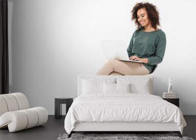 Attractive young african woman sitting on a chair Wall mural