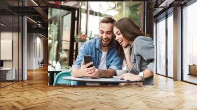 Attractive young couple in love having lunch Wall mural