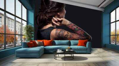 Back view of pretty young woman with tattooed hand Wall mural