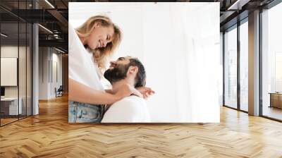 Beautiful happy young couple in love embracing at home Wall mural