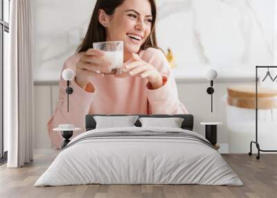 Beautiful smiling young girl having tasty healthy breakfast Wall mural