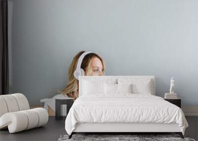 Beautiful young blonde woman relaxing in bed Wall mural