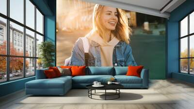 Beautiful young blonde woman wearing denim jacket Wall mural