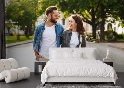 Beautiful young couple in love walking outdoors at the city street Wall mural