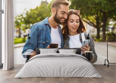 Beautiful young couple in love walking outdoors at the city street Wall mural