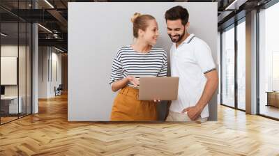 Beautiful young couple wearing casual clothing standing Wall mural