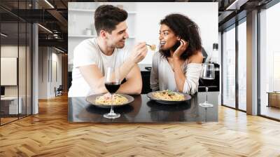 Beautiful young multiethnic couple having a romantic dinner Wall mural