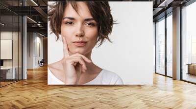 Beautiful young pretty thinking thoughtful woman posing isolated over white wall background. Wall mural