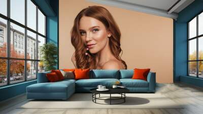 Beauty portrait of smiling ginger woman with long hair posing Wall mural