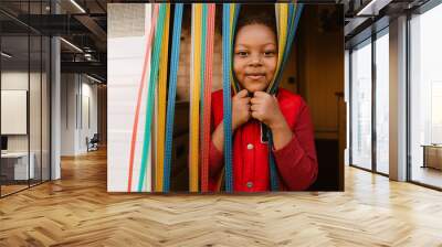 Black girl smiling while making fun with taps in trailer Wall mural