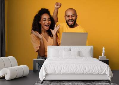 Black man and woman making winner gesture while using laptop Wall mural