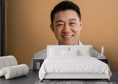 Brunette adult asian man wearing shirt smiling at camera Wall mural