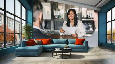 business, career and placement concept - young asian woman smiling and holding resume, while sitting Wall mural