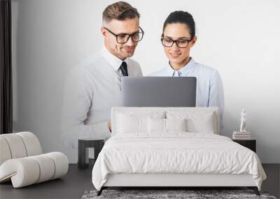 Business colleagues couple isolated over white wall background using laptop computer. Wall mural