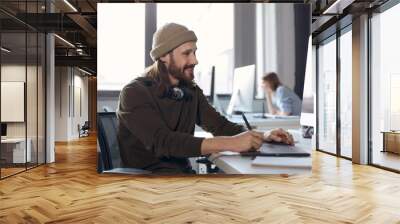 Business man writing in graphics tablet at office Wall mural