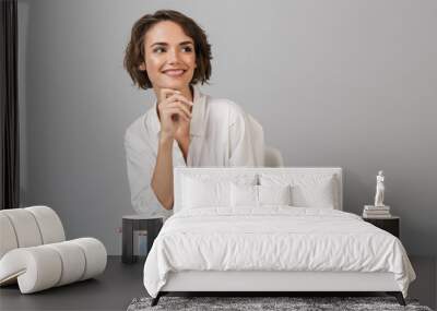 Business woman posing isolated over grey wall Wall mural