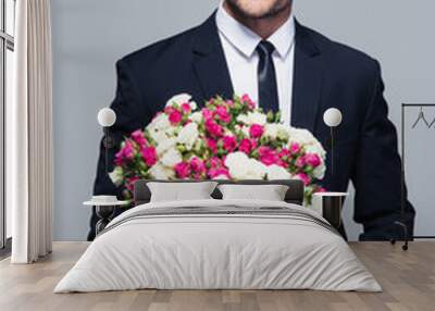 Businessman holding flowers Wall mural