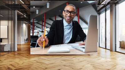 Businessman smiling at the working place Wall mural