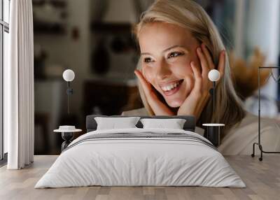 Caucasian cheerful woman smiling and looking aside Wall mural