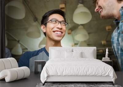 cheerful asian man talking with his friends Wall mural