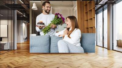 Cheerful attractive young couple celebrating birthday Wall mural